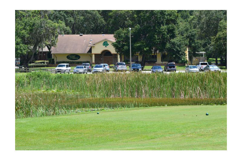 view of clubhouse and parking lot from course